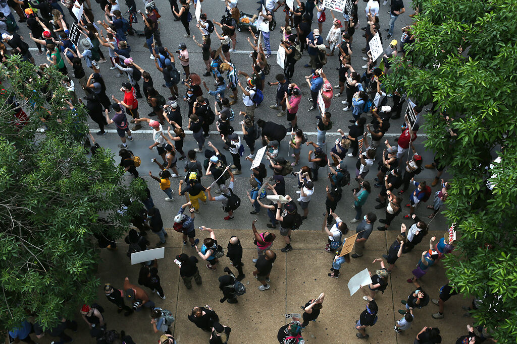 Hundreds of demonstrators march past Busch Stadium